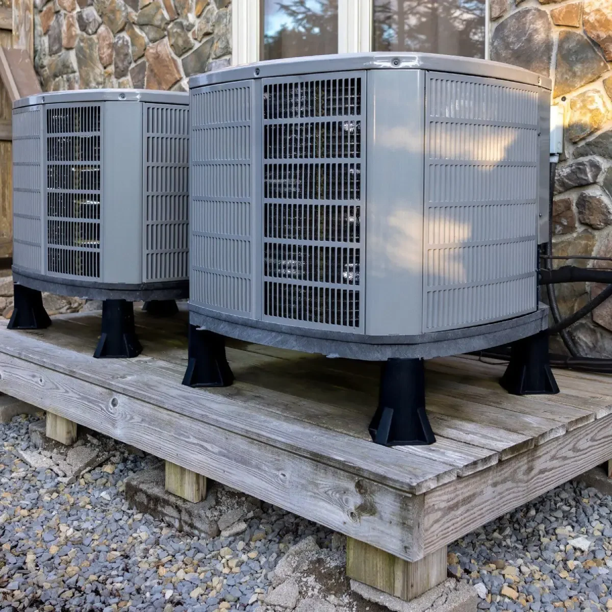 Two outdoor air conditioning units on platform.